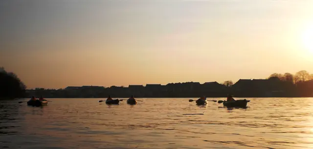 A group kayaking together on the River Thames